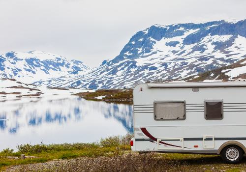 A camper in beautiful mountains near a lake