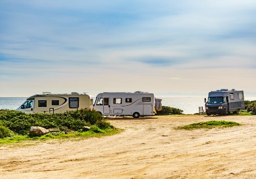 Campers are parked on the beachfront RV park
