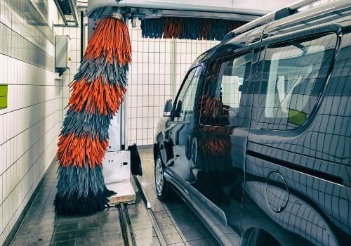 A campervan in the commercial carwash bay