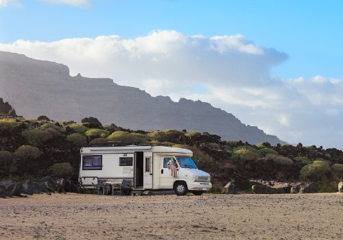 A caravan trailer with a security system parked on the beach