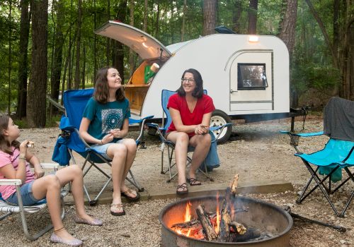 Family near a teardrop camper in outdoor