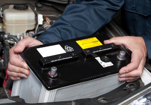 A mechanic changing the wrong type of battery