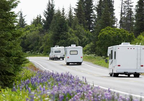A motorhome and travel trailers on the road