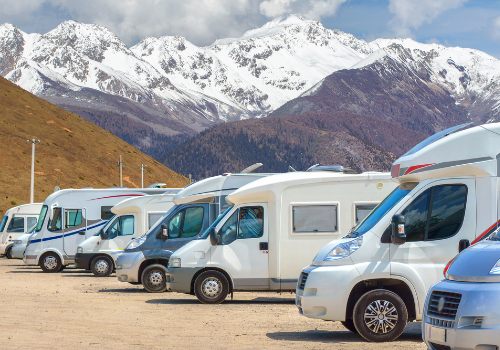 Motorhomes parked in a row on background snow