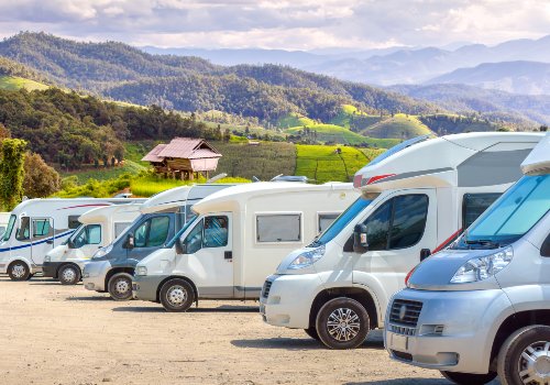 Motorhomes parked in a row on a beautiful landscape