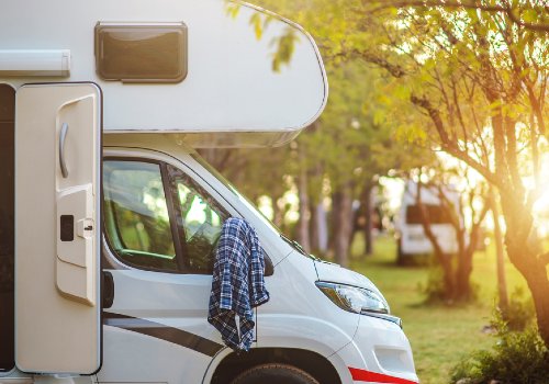 A recreational vehicle on a summer road trip