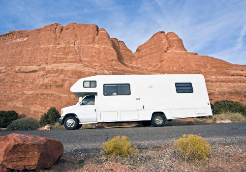 An RV in front of red rocks