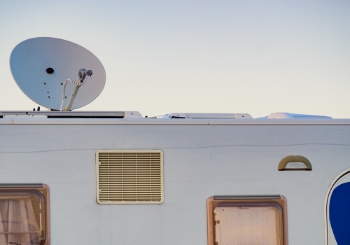 A satellite dish on a roof of a camper vehicle