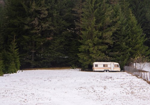 A travel trailer on snow in the forest