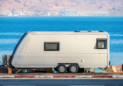 A travel trailer parked near the lake